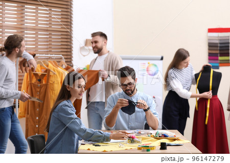 Fashion designers creating new clothes in studio Fashion designers creating new clothes in studio 96147279