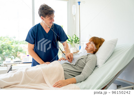 Young Caucasian doctor use stethoscope to check or diagnosis the symptom of senior patient Young Caucasian doctor use stethoscope to check or diagnosis the symptom of senior patient 96150242