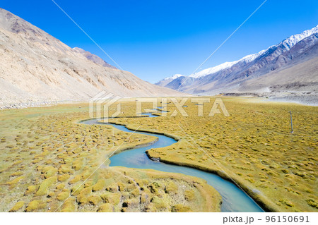 Landscape aerial view of mountains with river and green valley in Himalayas with blue sky in Nubra valley, Jammu and Kashmir, India. Landscape aerial view of mountains with river and green valley in Himalayas with blue sky in Nubra valley, Jammu and Kashmir, India. 96150691