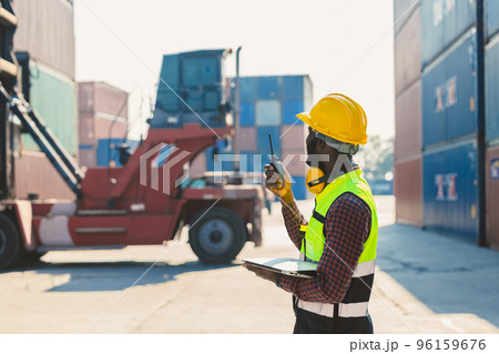 customs shipping staff worker working at cargo port container ship yard with radio control 96159676