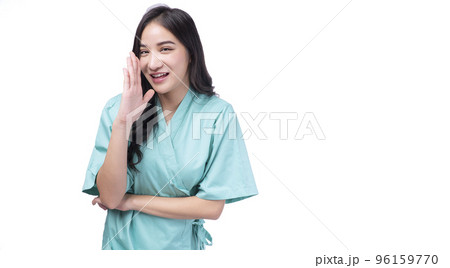 Happy asian woman wear pain holding hand aside mouth announce good news standing on white background 96159770