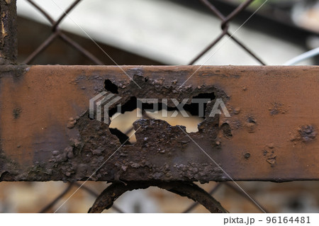 Rusty metal fencing partially destroyed by corrosion. Rusty metal fencing partially destroyed by corrosion. 96164481