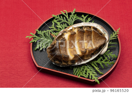 おせち料理その5-2_黒皿に盛った殻付きアワビの酒蒸し_背景赤 96165520