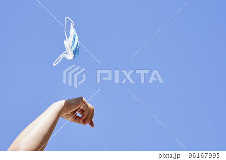 someone flying a kite in the air with their hand and fingers extended to one another person's arm, against a blue sky background 96167995