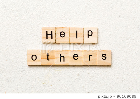 Help others word written on wood block. Help others text on table, concept Help others word written on wood block. Help others text on table, concept 96169089
