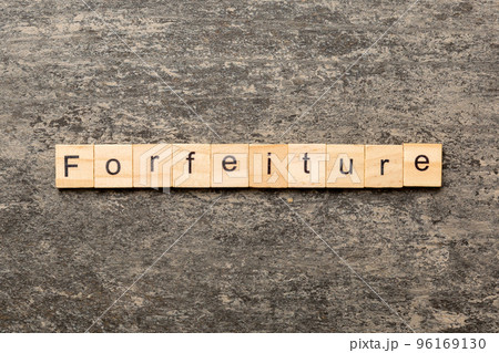 forfeiture word written on wood block. forfeiture text on table, concept 96169130