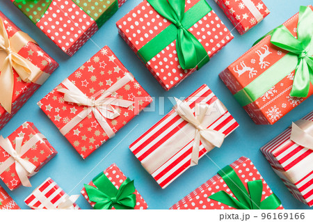 A lot of Christmas gift boxes in colored paper decorated on table, Top view close up. Many present New Year gift A lot of Christmas gift boxes in colored paper decorated on table, Top view close up. Many present New Year gift 96169166