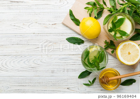 Caipirinha, Mojito cocktail, vodka or soda drink with lime, mint and straw on table background. Refreshing beverage with mint and lime in glass top view flat lay 96169404