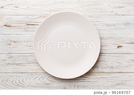 Top view of empty light plate on wooden background. Empty space for your design 96169707