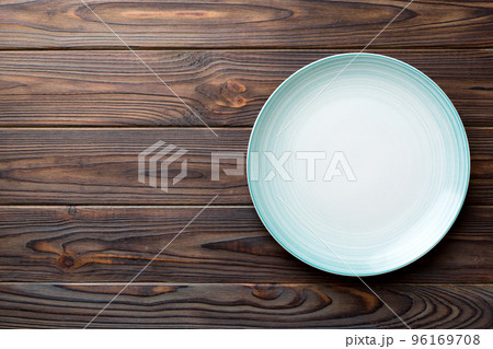 Top view of empty blue plate on wooden background. Empty space for your design 96169708