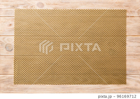 Top view of brown tablecloth for food on wooden background. Empty space for your design Top view of brown tablecloth for food on wooden background. Empty space for your design 96169712