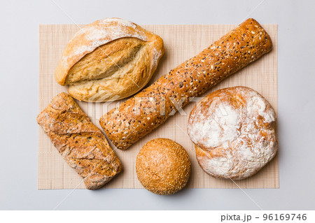 Assortment of freshly baked bread with napkin on rustic table top view. Healthy unleavened bread. French bread 96169746