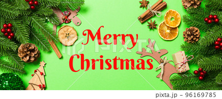 Merry Christmas text. Top view Banner of Christmas decorations on green background. New Year holiday concept with copy space 96169785