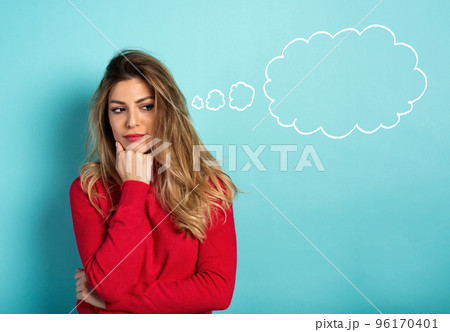 Confused woman have to choose something. Concept of options, confusion, decision. Cyan background Confused woman have to choose something. Concept of options, confusion, decision. Cyan background 96170401