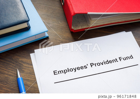 Documents about Employees Provident Fund and red folder. 96171848