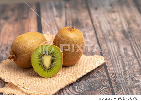 A half of kiwi on the wood table 96175678