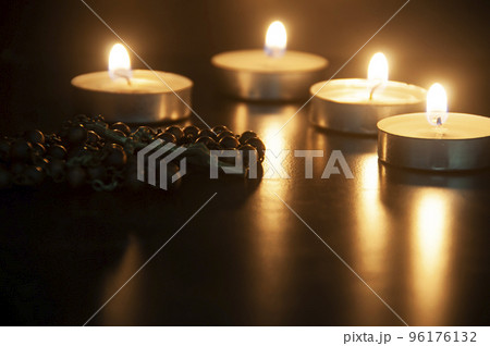 Holy Rosary on dark candlelight background with customizable space for text or ideas. Christianity concept. 96176132