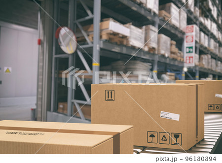 Cardboard boxes on conveyor rollers inside a warehouse ready to be shipped by courier for distribution 96180894