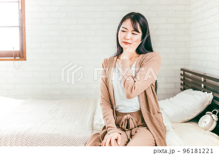 ベッドに座って虫歯・歯周病・ヘルペスで悩む日本人女性 ベッドに座って虫歯・歯周病・ヘルペスで悩む日本人女性 96181221