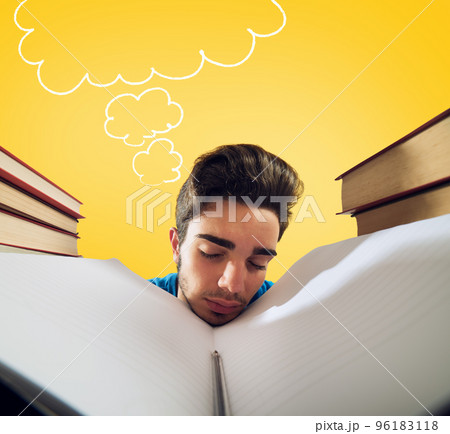 Exhausted student is studying hard on the desk Exhausted student is studying hard on the desk 96183118