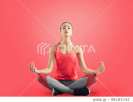 Young girl relaxing in yoga position on red background 96185142