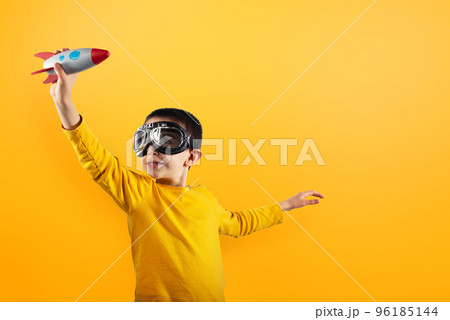 Child plays with a rocket. Concept of imagination. 96185144