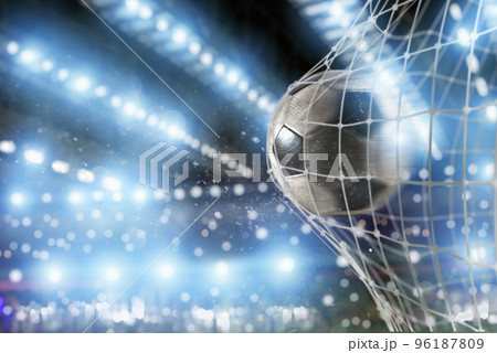 Soccer ball scores a goal on the net 96187809