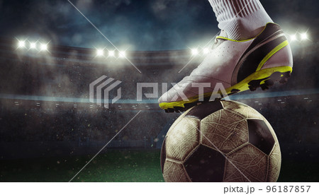 Close up of a soccer striker ready to kicks the ball at the stadium 96187857