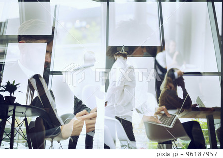 Business people collaborate together in office. Double exposure effects Business people collaborate together in office. Double exposure effects 96187957