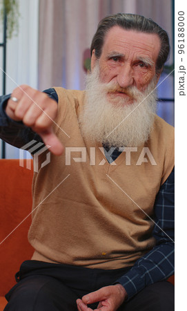 Upset senior man showing thumbs down, dislike bad work, disapproval, dissatisfied feedback at home Upset senior man showing thumbs down, dislike bad work, disapproval, dissatisfied feedback at home 96188000
