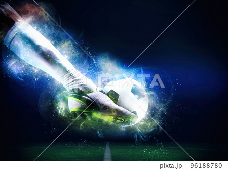 Football scene at night match with player ready to shoot the ball Football scene at night match with player ready to shoot the ball 96188780