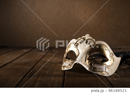 Stll life of a carnival mask on a wood floor 96189521