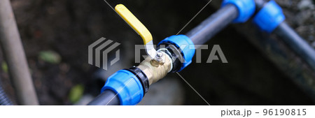 Water valve connected to PVC pipe closeup Water valve connected to PVC pipe closeup 96190815