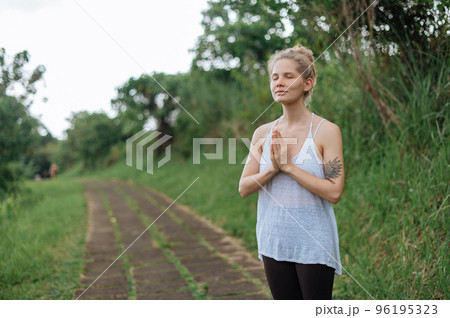 Girl practice yoga meditation outdoor in park 96195323