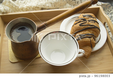 morning Breakfast in bed a Cup of coffee with croissant on wooden tray 96198003