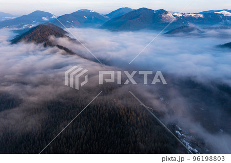 Carpathian peaks in the morning in the clouds, top view, drone footage. Carpathian peaks in the morning in the clouds, top view, drone footage. 96198803