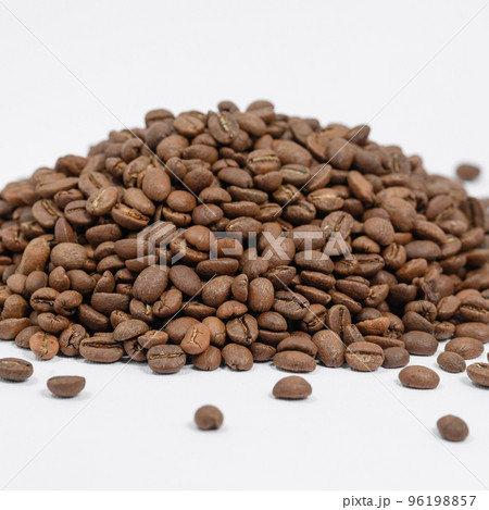 A pile of coffee beans on a white background, place for advertising. A pile of coffee beans on a white background, place for advertising. 96198857