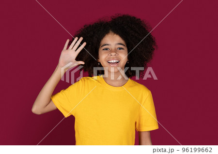 Portrait of cheerful african american kid girl waving at camera 96199662
