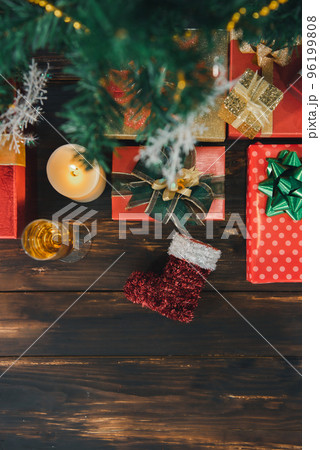 Christmas lights and decoration on the wooden board with presents making a frame with copy space, top view. Christmas lights and decoration on the wooden board with presents making a frame with copy space, top view. 96199808