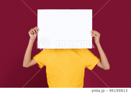 Unrecognizable african american child hiding behind empty placard Unrecognizable african american child hiding behind empty placard 96199813