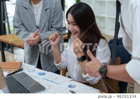 A portrait of three Asian business showing joy from sales of new projects that meet customer demand. 96201334
