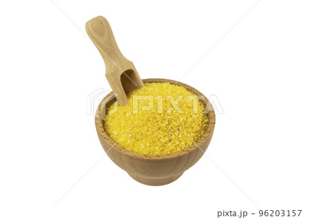 corn grits in wooden bowl and scoop isolated on white background. nutrition. food ingredient. corn grits in wooden bowl and scoop isolated on white background. nutrition. food ingredient. 96203157