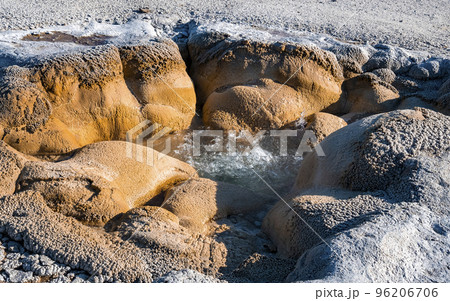 Close-up of boiling water in Shell spring. Eruption at geothermal landscape in Biscuit basin geyser. Famous attraction in Yellowstone National park during sunny day. Close-up of boiling water in Shell spring. Eruption at geothermal landscape in Biscuit basin geyser. Famous attraction in Yellowstone National park during sunny day. 96206706