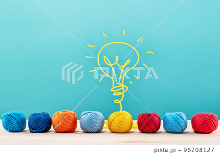 Colored wool balls that do a lightbulb with the wire. Concept of creativity and idea 96208127