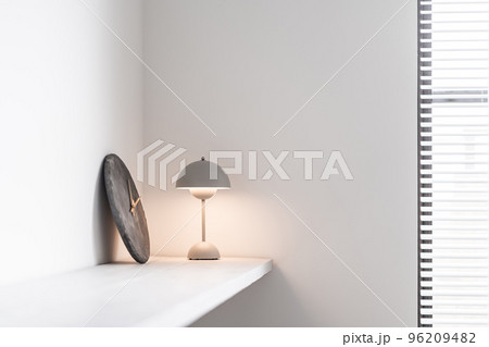 棚に置いてある時計とライトスタンド 96209482