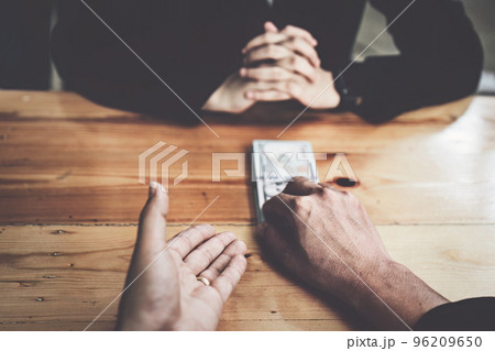 Corrupt concept, corrupt private entrepreneurs are handing over money to government employees to offer to sign contracts that benefit their company. Corrupt concept, corrupt private entrepreneurs are handing over money to government employees to offer to sign contracts that benefit their company. 96209650