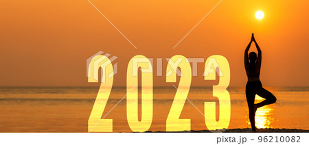 Happy new year card 2023. Silhouette lifestyle woman yoga practicing yoga standing as part of Number 2023 Happy new year card 2023. Silhouette lifestyle woman yoga practicing yoga standing as part of Number 2023 96210082