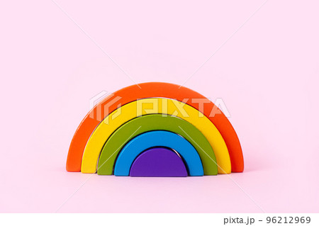 Education kid arch toy , pastel pyramid game on pink background. Colorful wooden figure on yellow background, kid play concept Education kid arch toy , pastel pyramid game on pink background. Colorful wooden figure on yellow background, kid play concept 96212969