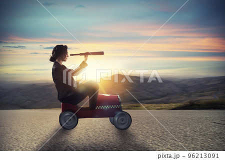 Businesswoman with telescope on a car looks for new business opportunity Businesswoman with telescope on a car looks for new business opportunity 96213091