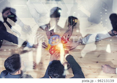 Business team connect pieces of gears. Photo from above. Teamwork, partnership and integration concept. Double exposure Business team connect pieces of gears. Photo from above. Teamwork, partnership and integration concept. Double exposure 96213139